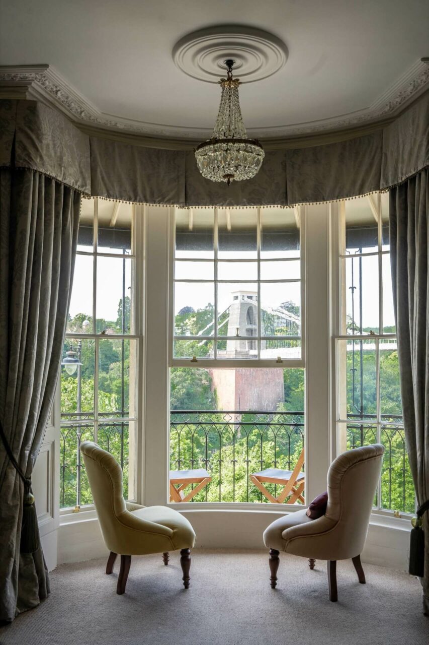 Two armchairs in front of finished double glazed sash windows overlooking Bristol Suspension Bridge by New Life Sash Window Co